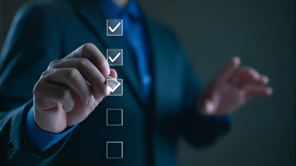 Hand checking items on a digital checklist, representing investment app selection.